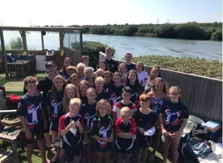 Swimming team photo in front of the lake at Action Watersports